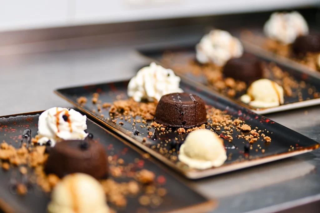 Rich chocolate lava cake with vanilla ice cream, whipped cream, and cookie crumble served at Konoba Malo Misto in Zadar