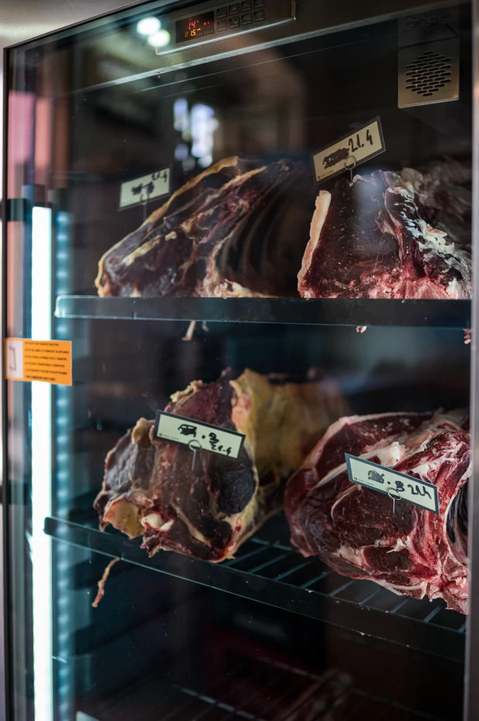 Dry-aged beef cuts stored in a temperature-controlled meat cabinet at Konoba Malo Misto steak and seafood restaurant in Zadar