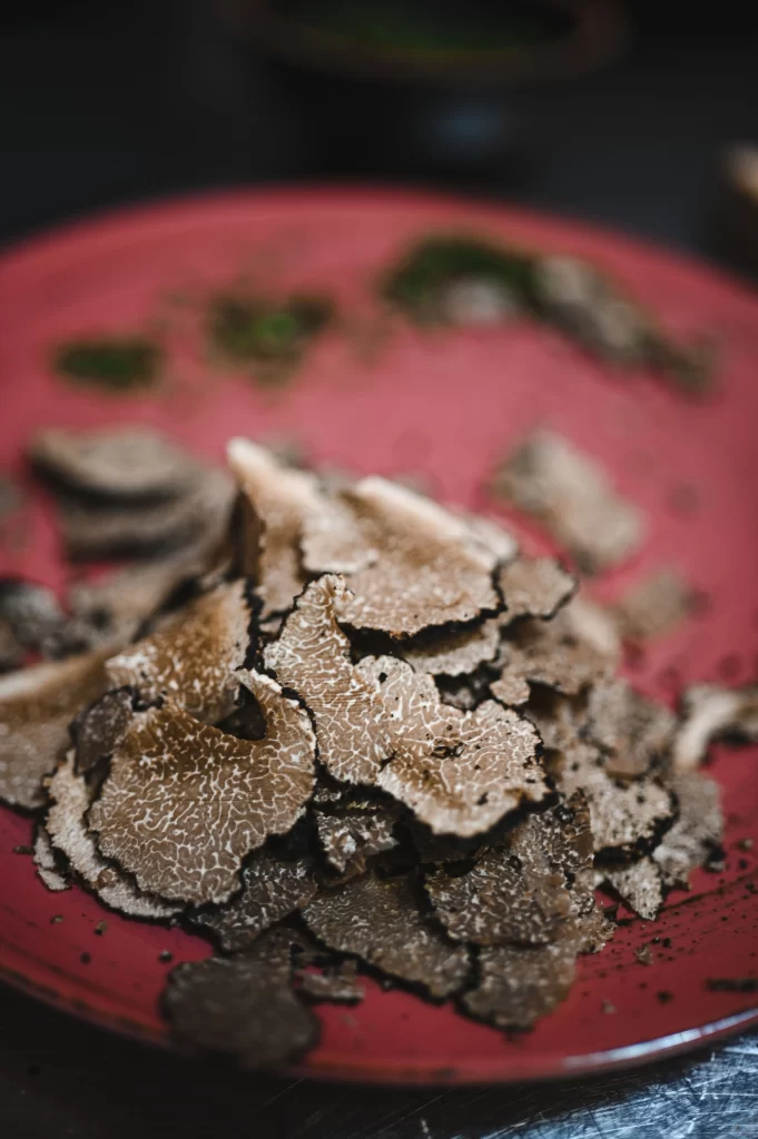 Pile of freshly shaved black truffle slices on a plate at Konoba Malo Misto, a gourmet restaurant in Zadar