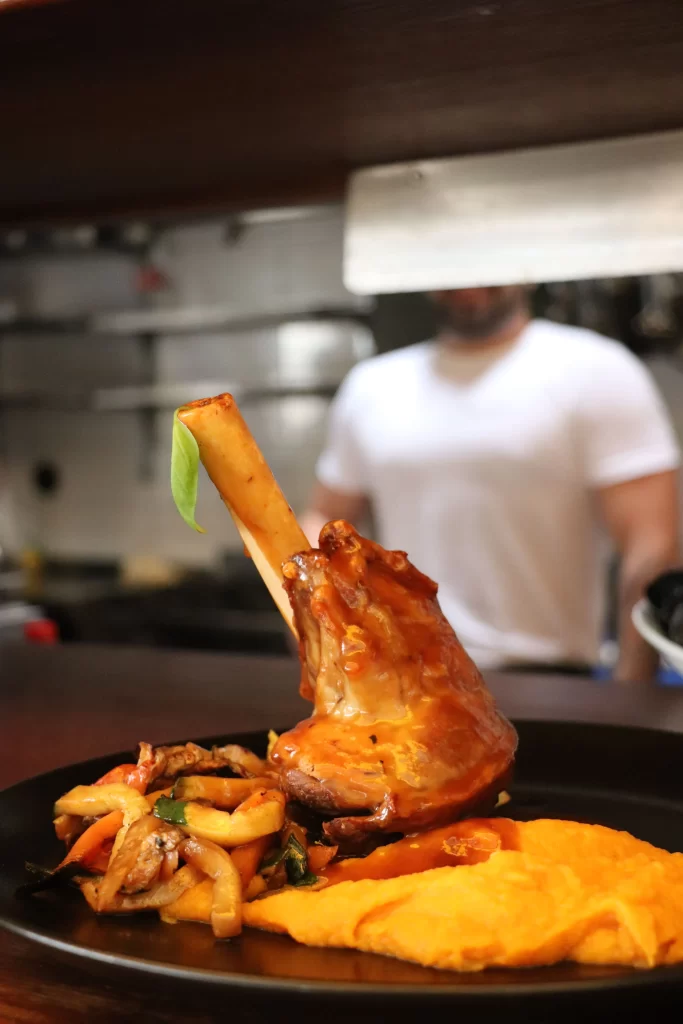 Slow-cooked lamb shank served with sautéed vegetables and sweet potato purée at Konoba Malo Misto restaurant in Zadar