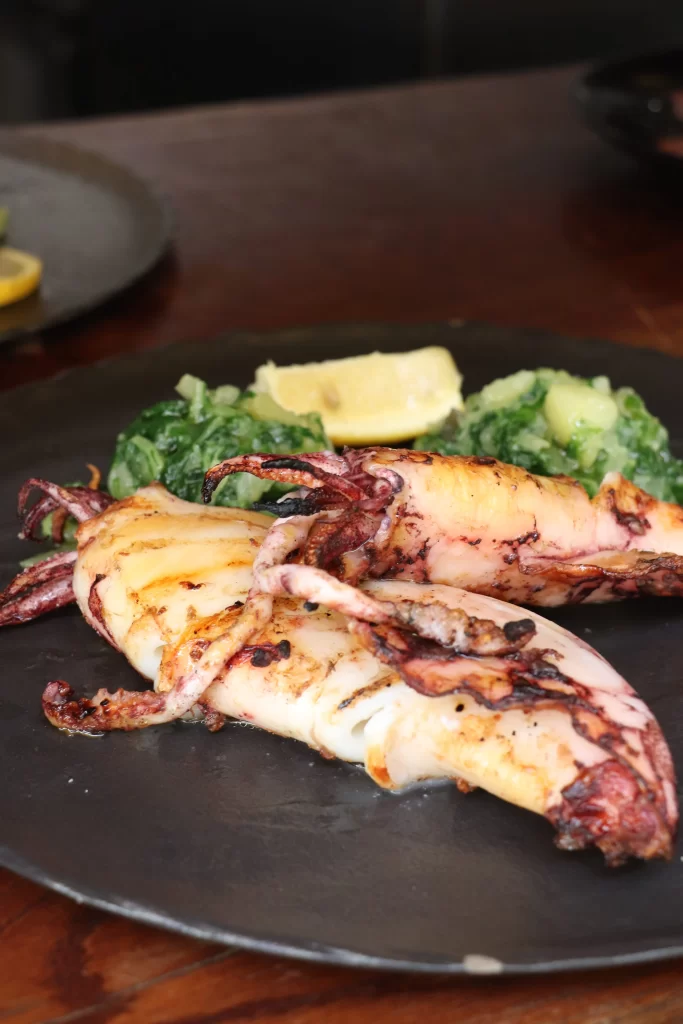 Grilled Adriatic squid served with blitva and potatoes at Konoba Malo Misto, a traditional Croatian restaurant in Zadar