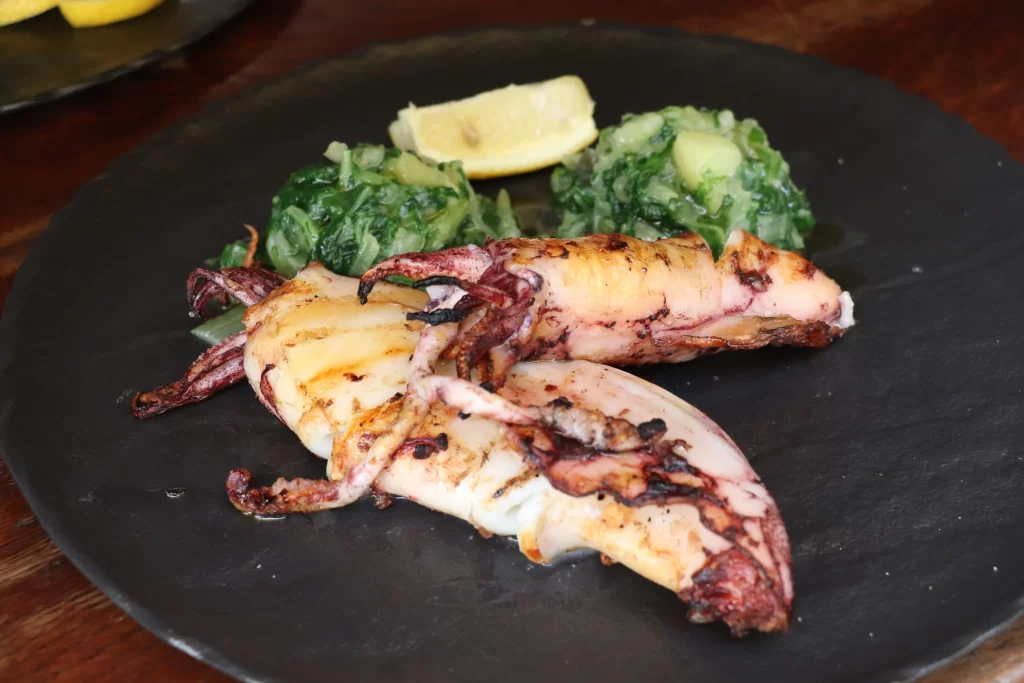 Grilled Adriatic squid served with blitva and potatoes at Konoba Malo Misto, a traditional Croatian restaurant in Zadar