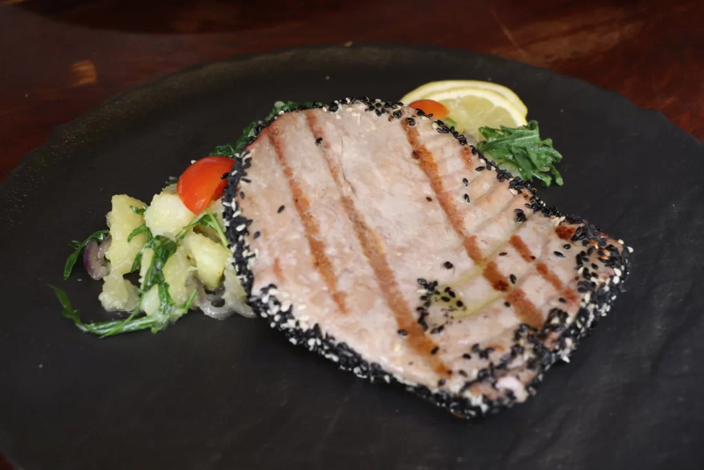 Sesame-crusted tuna steak served with warm potato salad and rocket at Konoba Malo Misto restaurant in Zadar