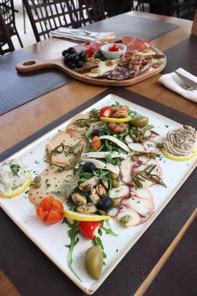 Seafood platter featuring octopus carpaccio, shrimp, mussels, anchovies, tuna pâté, and Mediterranean garnishes served at Konoba Malo Misto in Zadar