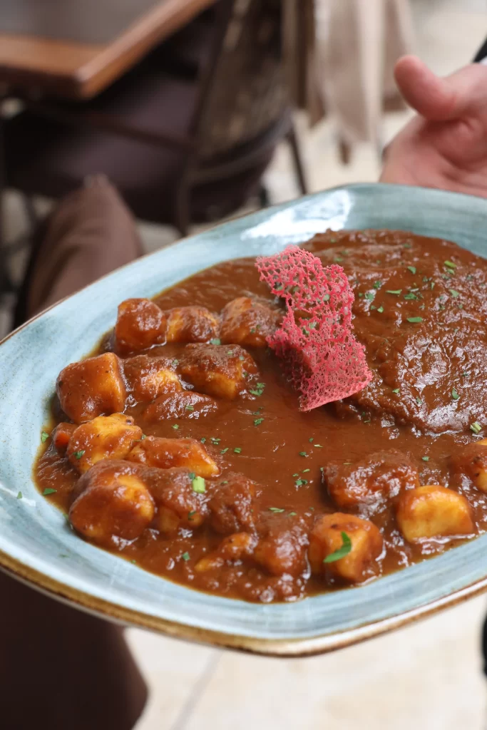 Dalmatian pašticada – traditional beef stew in rich red wine sauce with gnocchi and a decorative red tuile, served at Konoba Malo Misto