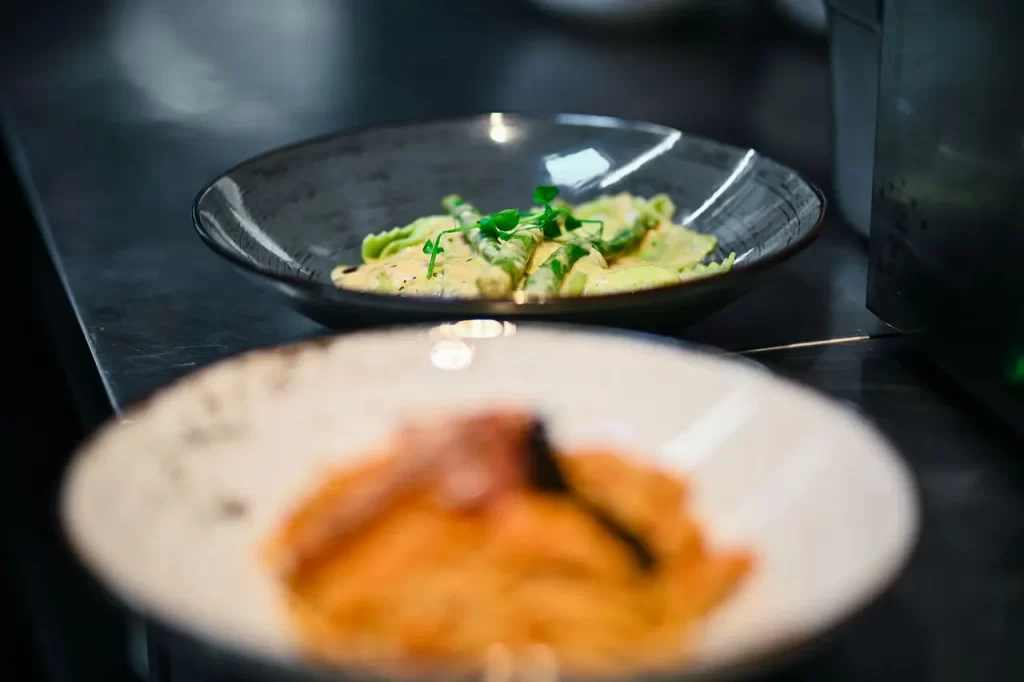 Two pasta dishes served at Konoba Malo Misto in Zadar – creamy green gnocchi and seafood linguine