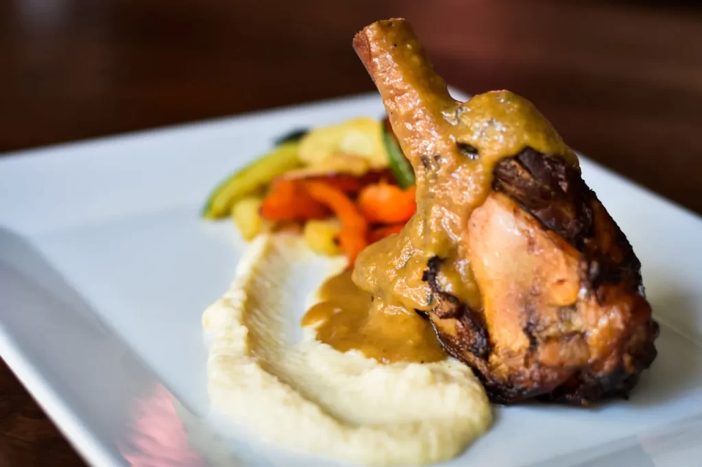 Slow-cooked lamb shank with creamy mashed potatoes and seasonal vegetables at Konoba Malo Misto Zadar